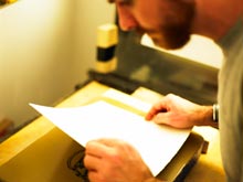 Paper being laid on a stone.